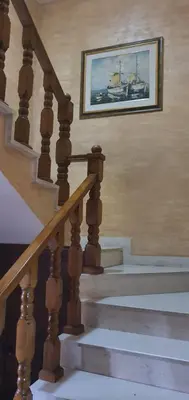 a staircase with a picture of a boat on the wall at Anika in Podgorica