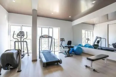 a gym with many exercise equipment in a room at Maris View in Becici
