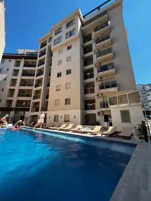 a large swimming pool in front of a building at Apartment Montenegro Becici in Becici