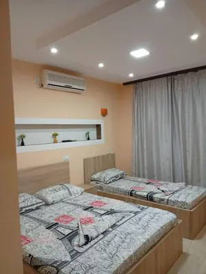a bedroom with two beds and a window at Grandino rooms& apartments in Ulcinj