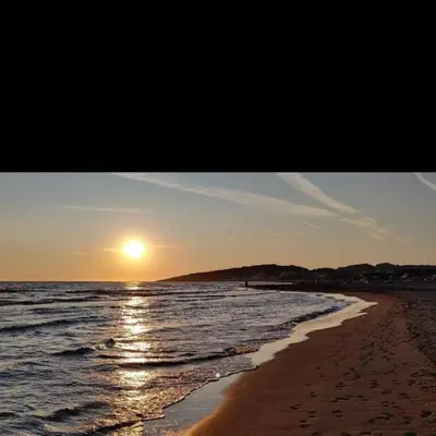 a picture of a beach with the sun setting at Grandino Space room&apart Ulqin in Ulcinj