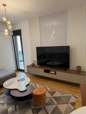 a living room with a large flat screen tv at Montenegro Platinum Suite - New City in Podgorica