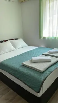 a bed with two towels sitting on top of it at Lupo in Budva