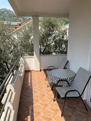 a balcony with two chairs and a table on it at Lupo in Budva