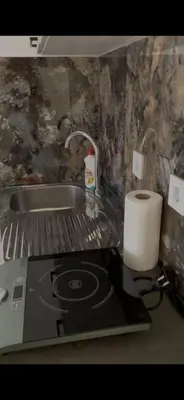 a kitchen counter with a stove and a roll of paper towels at Apartment Lupo in Budva