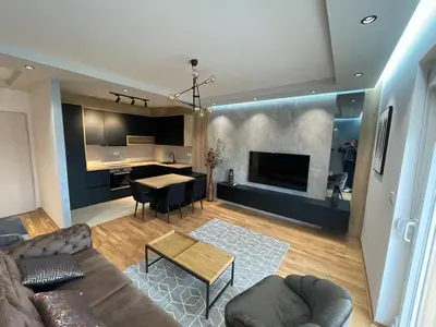 a living room with a couch and a table at Montenegro Black Suite in Podgorica