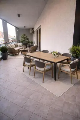 a dining room with a table and chairs at New sea view luxury apartment in center in Budva
