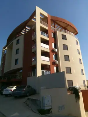 a building with a car parked in front of it at Apartment Sea Space in Dobra Voda