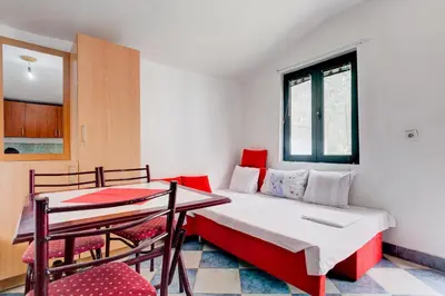 a small room with a bed and a table at Raj mira in Utjeha