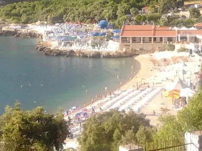 a beach with a bunch of people on the water at Apartment Carpe Diem 1 in Utjeha