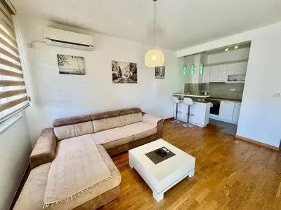 a living room with a couch and a table at Fanky City Apartments in Podgorica