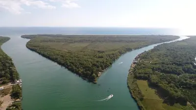 an aerial view of a river with a boat in it at 
