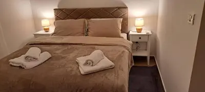 a bedroom with a bed with two towels on it at Auto kamp Titograd in Podgorica