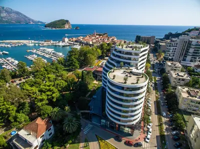 an aerial view of a large building next to the water at Royal Montesun Apartments in Budva