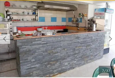 a kitchen with a brick counter in a kitchen at villa elkom-appartamento giallo 1 in Ulcinj