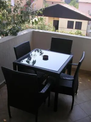 a black table and chairs with a cup on it at villa elkom-appartamento giallo 1 in Ulcinj