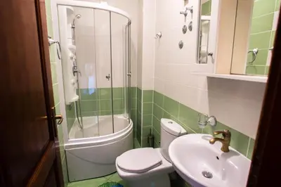 a bathroom with a toilet and a sink and a shower at Villa Elkom App 2 in Ulcinj