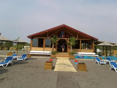 a man standing in front of a building with chairs at Villa Elkom, App. 8 in Ulcinj