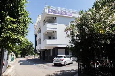 a white car parked in front of a building at Villa Elkom, App.11 in Donji Štoj