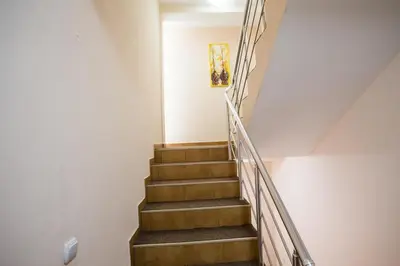 a staircase in a house with wooden steps at Villa Elkom, App.3 in Ulcinj