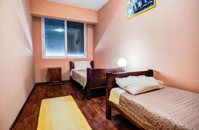 a bedroom with two beds and a window at Villa Elkom, App.4 in Ulcinj
