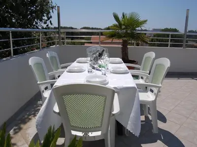 a white table and chairs on a patio at Villa Elkom, App 14 in Ulcinj
