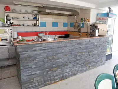 a kitchen with a brick counter in a kitchen at Villa Elkom, App 16 in Ulcinj