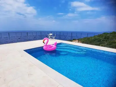 a pink swan toy in a swimming pool at Charming Villa with Pool, Sea View in Zagora in Zagora