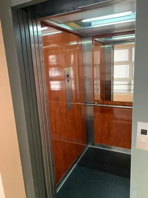 a glass door of a elevator in a building at Blue Sky Apartment in Petrovac na Moru