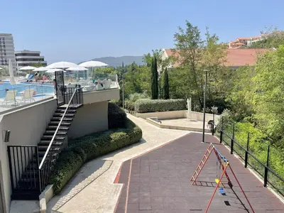 a walkway with a staircase next to a pool at Status-M Аpartments 173 in Becici