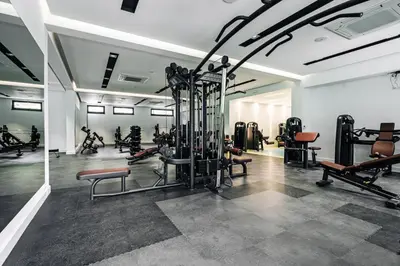a gym with a bunch of equipment in a room at Status-M Apartments 205 in Becici