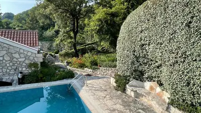 an overhead view of a swimming pool next to a wall at Mountains Villa near Budva in Budva