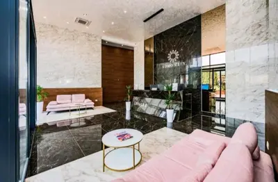 a living room with a pink couch and a table at Bar Exclusiv Soho city Residence in Bar