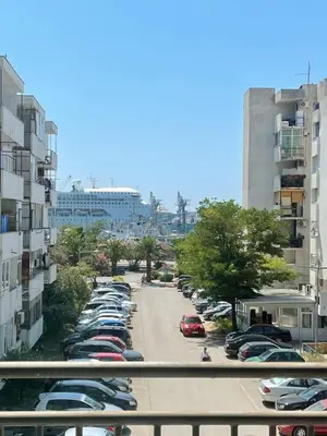 a parking lot full of cars in a city at Seaview Apartment in Bar