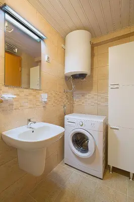 a bathroom with a washing machine and a sink at Apartment Ana in Budva
