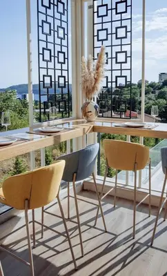 a dining room with a table and two chairs at Status-M apartments 98 in Becici