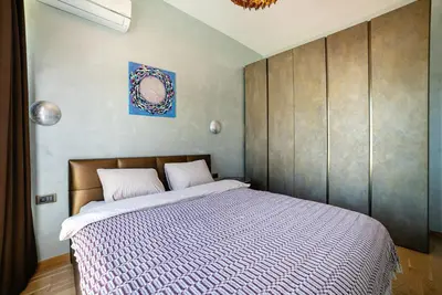 a bedroom with a large bed with a wooden headboard at The Dream Getaway & Spa by DeVasco in Becici