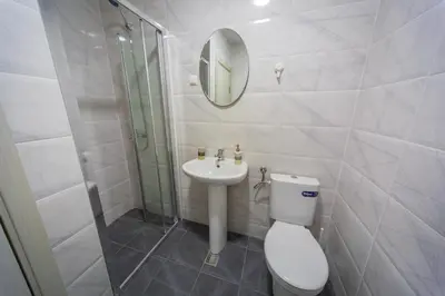 a bathroom with a toilet and a sink and a mirror at Blue moon apartment in Podgorica