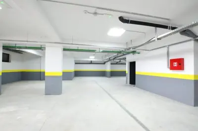 an empty parking garage with yellow and white walls at Horizon one bedroom apartment NS in Becici