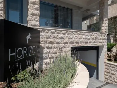 a sign for a hotel in front of a building at Horizon one bedroom apartment NS in Becici