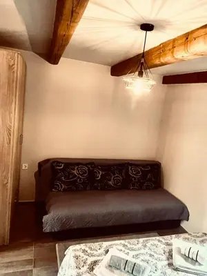 a bedroom with a bed and a ceiling fan at Old wine in Virpazar
