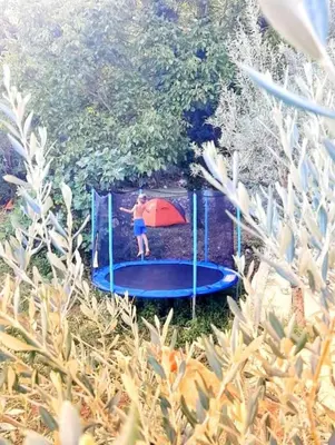 a young boy is playing on a trampoline at Old wine in Virpazar