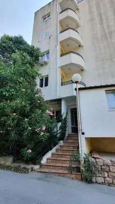 a building with stairs and a tree next to it at Mini Candy central location Bečići in Becici
