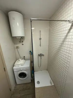 a small bathroom with a shower and a toilet at Delta apartment City kvart in Podgorica