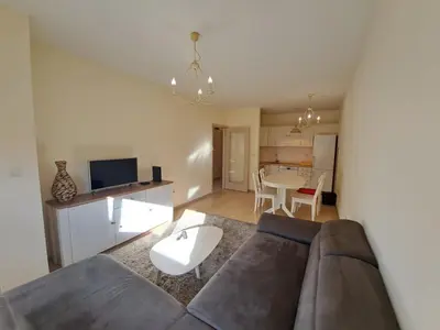 a living room with a couch and a table at Delta apartment City kvart in Podgorica