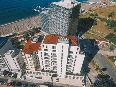 an aerial view of a tall building next to the ocean at Luxury apartment Casa Al Mare in Rafailovici