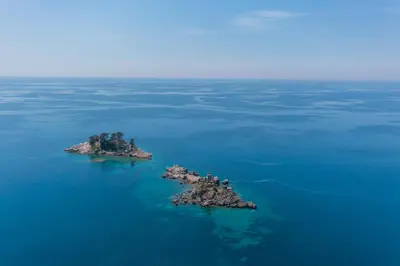 an island in the water with birds on it at Apartments Del Mar in Petrovac na Moru